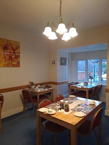 a dining room with tables and chairs and a window at The Sandgate in Skegness