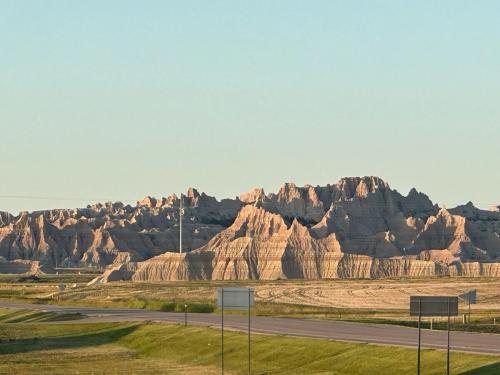 a road in front of some rocky mountains at Buffalo Drift Tiny Home in Interior
