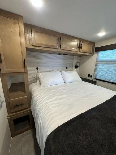 a bedroom with a large bed in an rv at Buffalo Drift Tiny Home in Interior