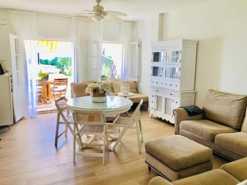a living room with a table and a couch at Charming oceanfront property in Casas Devesa
