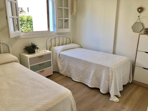 a room with two beds and a window at Charming oceanfront property in Casas Devesa