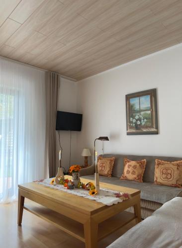 a living room with a couch and a coffee table at Ferienwohnung Wood in Nonnweiler