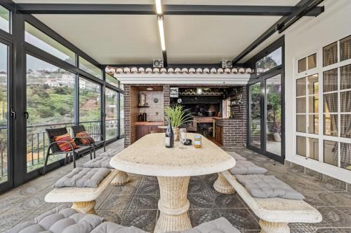 a dining room with a table and chairs at Ocean Hill View By Zest&Guest in Câmara de Lobos