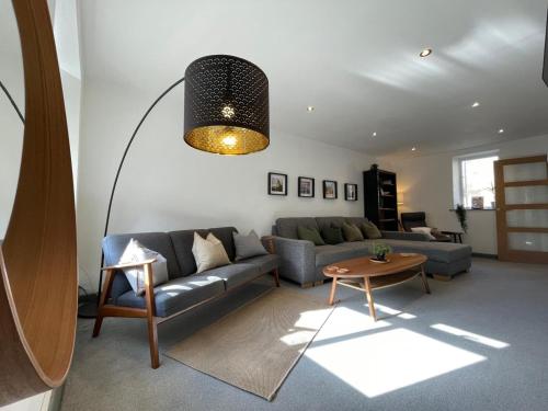 a living room with a couch and a table at Spacious City Centre Property in Lancaster