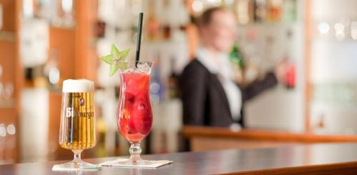 two drinks sitting on a table next to a drink at Hotel am Rosengarten in Bad Wimpfen