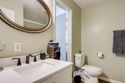 a bathroom with a sink and a toilet and a mirror at 1 Mi to Shops and Cafes Updated Cassville Home! in Cassville