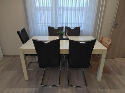 a dining room table with black chairs around it at Modern appartement with big terrace in Ljubljana in Ljubljana