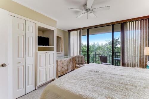 a bedroom with a large bed and a balcony at Oceanfront 3 Bedrooom BeachWalker Condo in Amelia Island