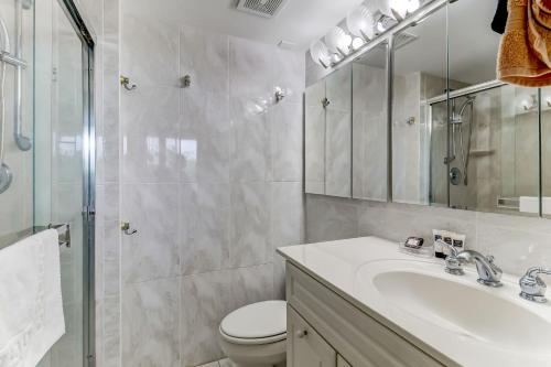 a bathroom with a sink and a toilet and a shower at Oceanfront 3 Bedrooom BeachWalker Condo in Amelia Island