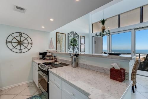a kitchen with white walls and windows and a counter top at Oceanfront 2 Bedrooom with sleeping loft in Franklintown