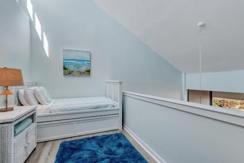 a white room with a bed and a window at Oceanfront 2 Bedrooom with sleeping loft in Franklintown
