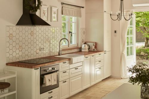a kitchen with white cabinets and a sink at Nad svatým Kiliánem 