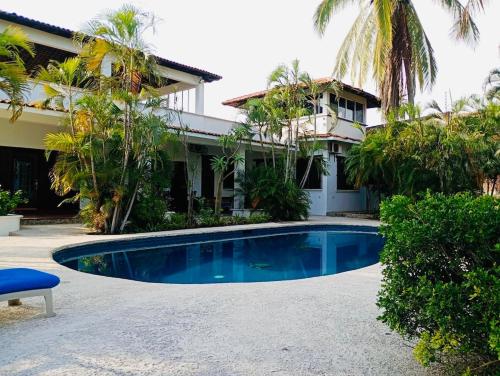 a swimming pool in front of a house at Casa Horizonte Ocean view and Carrizalillo access in Puerto Escondido