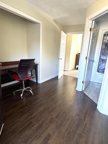an empty room with a desk and a chair at Lincoln Inn Fredericton in Fredericton