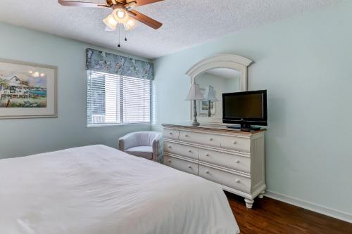a bedroom with a bed and a dresser with a tv at Two Bedroom Beachwood Condo 2118 in Franklintown