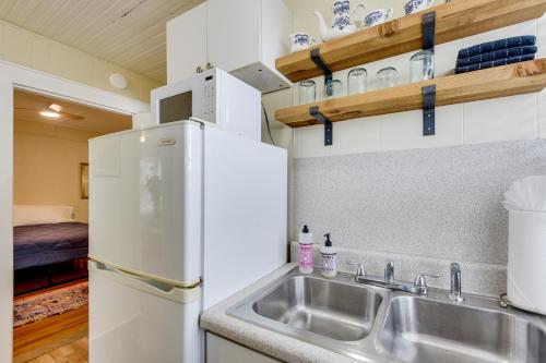 a kitchen with a sink and a refrigerator at Less Than 1 Mi to Dtwn Bradenton and Riverwalk! Sunny Apt in Bradenton