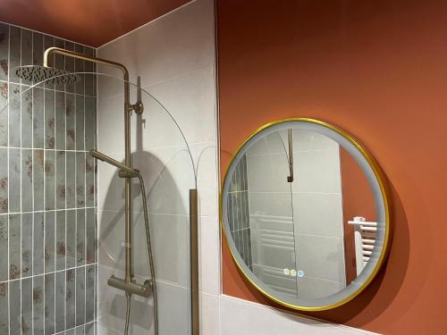 a bathroom with a round mirror and a shower at Suite Romantique - Love Room Valence Amour et Bulles - Jacuzzi - Lit king size avec miroir XXL - Sofa Tantra - Drôme Ardèche in Bourg-lès-Valence