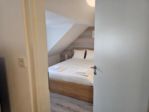 an open door to a bedroom with a bed at private apartment in Luxembourg