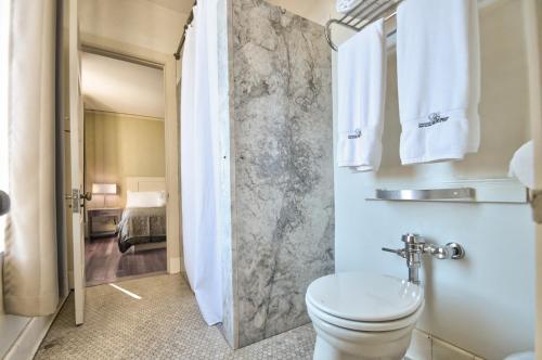 a bathroom with a sink and a toilet in a room at Centralia Square Grand Ballroom and Vintage Hotel in Centralia