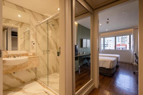 サンパウロにあるHotel Transamerica Berriniのバスルーム(ベッド1台、シンク、シャワー付)