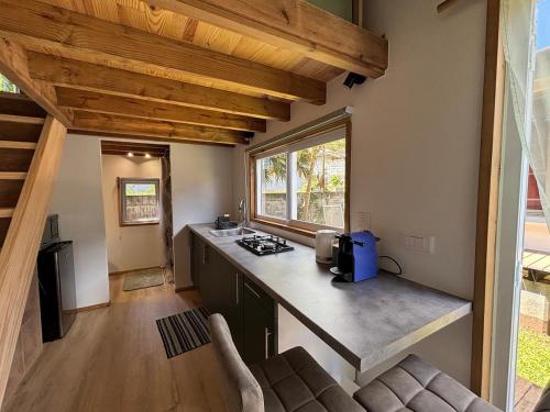 a kitchen with a counter top in a house at Tiny Surf in Punaauia