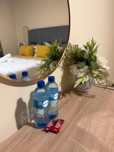 two bottles of water on a table in front of a mirror at Soulfenda guest house in Graskop