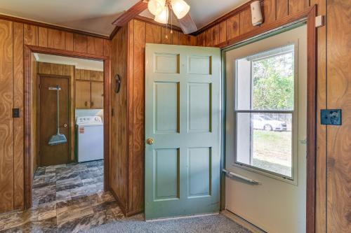 a kitchen with a green door and a window at Pet-Friendly Eutaw Home Near Historic Square in Eutaw