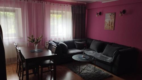 a living room with a couch and a table at Dom Kopernica 3 in Chełm