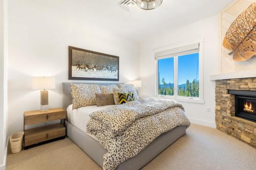 a bedroom with a bed and a fireplace at Moonlight Basin Lookout Patio Views & Ski In Out in Big Sky Mountain Village