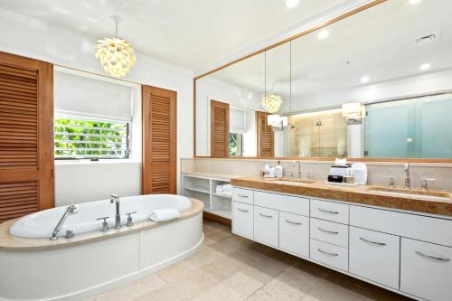 a bathroom with a tub and a large mirror at Montage Kapalua Bay 2 Free Rental Cars KBM Resorts Hale Mala At Montage Kapalua Bay Oceanfront Property 2 Units 6 Bedrooms ML-1161 in Honokahua
