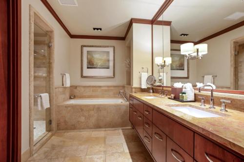 a bathroom with two sinks and a tub and a shower at Montage Kapalua Bay 2 Free Rental Cars KBM Resorts Beautiful Villa At Montage Kapalua Bay 2 Units 6 Bedrooms ML-1231 in Honokahua