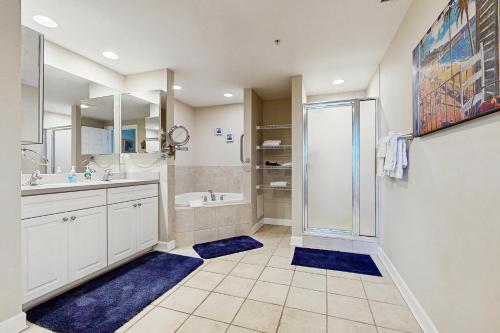 a bathroom with a shower and a sink and a tub at Emerson Towers 504 in Ocean City