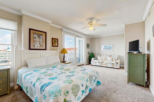 a bedroom with a bed and a tv and a couch at Emerson Towers 504 in Ocean City