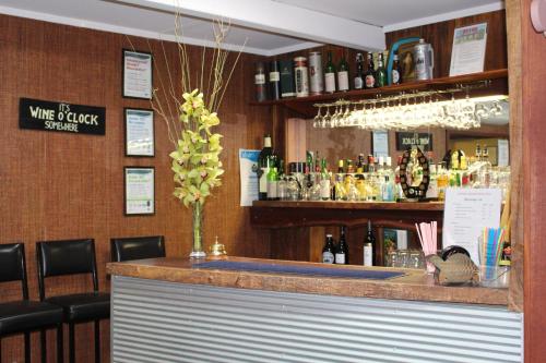 a bar in a restaurant with a counter and chairs at Cobram Colonial Motor Inn in Cobram