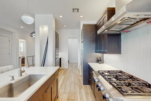 a kitchen with a sink and a stove top oven at Padre Villa 104 in Padre Island