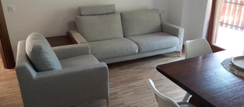 a living room with a couch and a table at Villa MB in Lenna