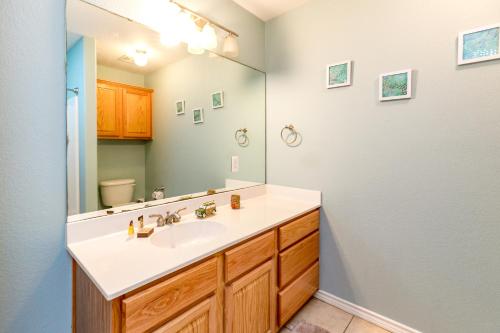 a bathroom with a sink and a mirror at NPI Hideaway Stay in Padre Island