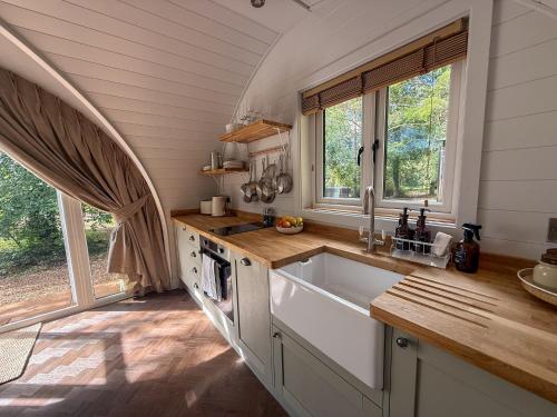 a kitchen with a sink and a large window at Liba Vineyard in Porton