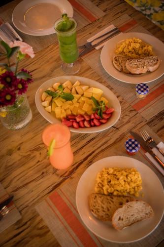 a wooden table with plates of food on it at Playa Banana Manzanillo del Mar in Cartagena de Indias