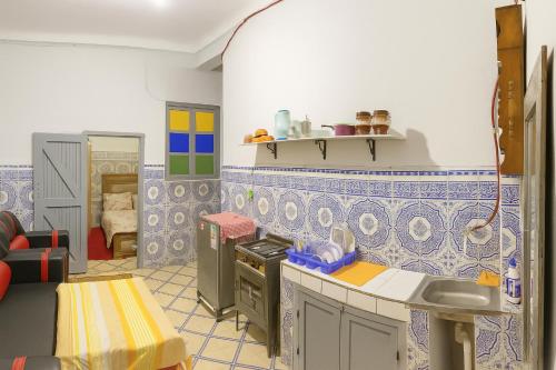 a kitchen with blue and white tiles on the wall at DAR Souaad Bab Doukkala in Marrakech