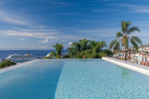 a swimming pool on top of a building with a view of the ocean at Villa Mangoni - Brand New Luxury Villa in Funchal