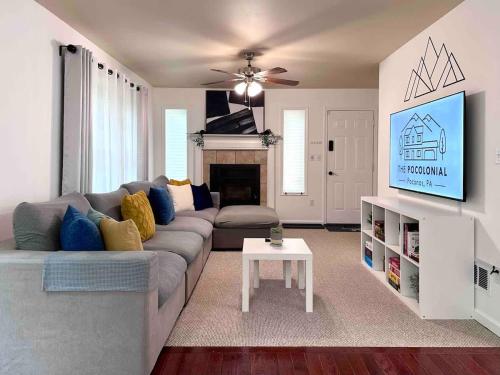 a living room with a couch and a tv at Pocolonial Charming 4BR Mountain Retreat in Towamensing Trails