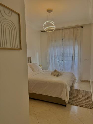 a bedroom with a large bed with a window at Yasmine Elixir in Casablanca