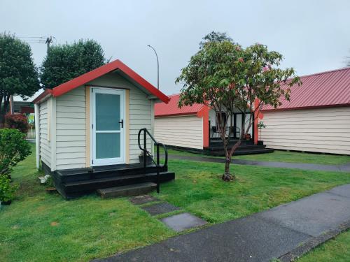 a small house with a red roof at Wharepai in Rotorua
