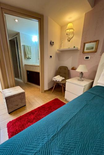 a bedroom with a blue bed and a living room at Casa Etna Soul in Paterno