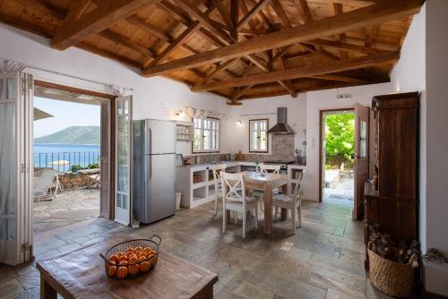 a kitchen with a table and a refrigerator at Lithea Villas and Studios by the Sea in Aghios Petros Alonissos