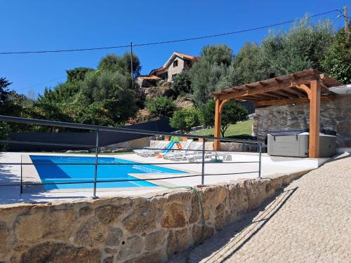 a swimming pool with a fence around it at Quinta da Estacao in Marco de Canavezes