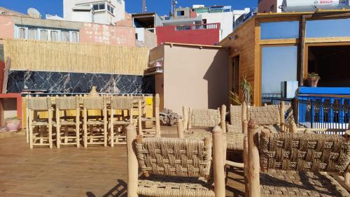 a group of chairs and tables on a patio at Habibi Hostel in Taghazout