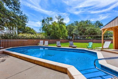 a swimming pool in a yard with chairs at 2070 - Sol Mates in Duck