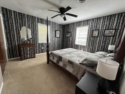 a bedroom with a bed and a ceiling fan at The Renovated Farmhouse at Seneca Rocks in Seneca Rocks